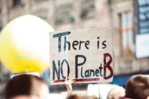 Protestors of climate change efforts - there is no planet b sign
